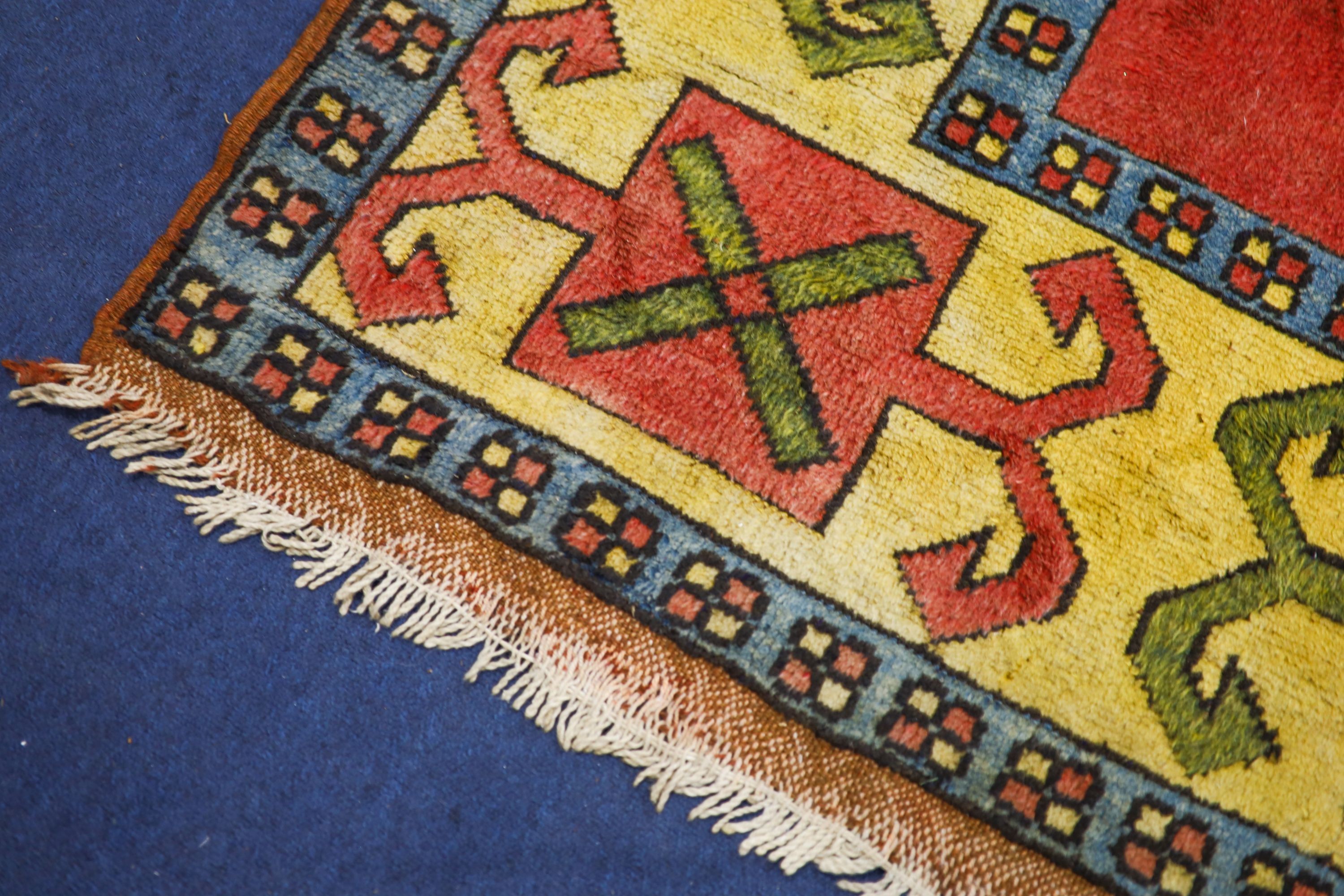 A Caucasian style red ground carpet, 290 x 200cm